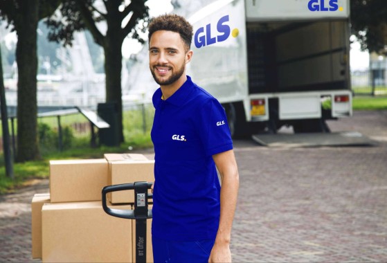 Happy driver getting pallet out of truck to deliver