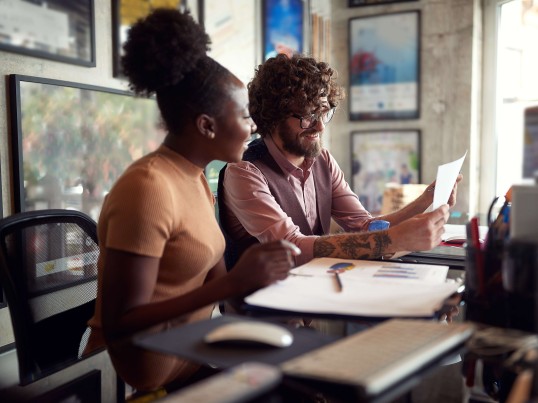 Two people working together at a computer