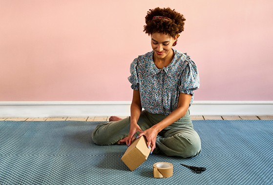 woman wrapping parcel to send with GLS