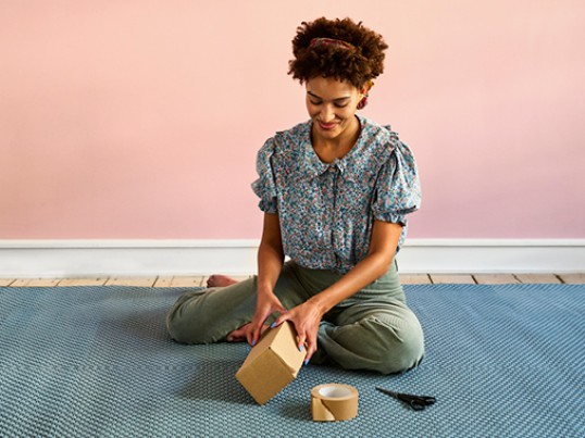 woman preparing parcel to be sent