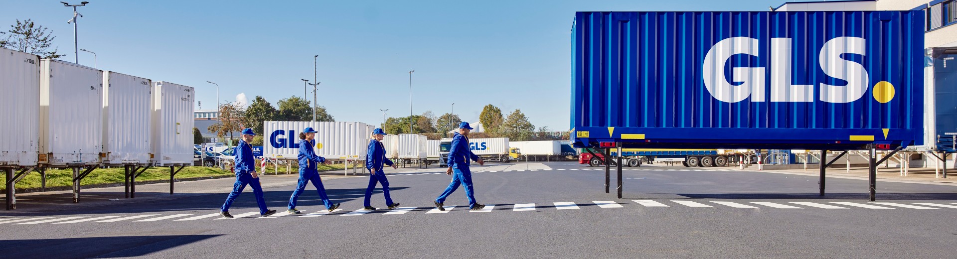 GLS employees walking along the crosswalk