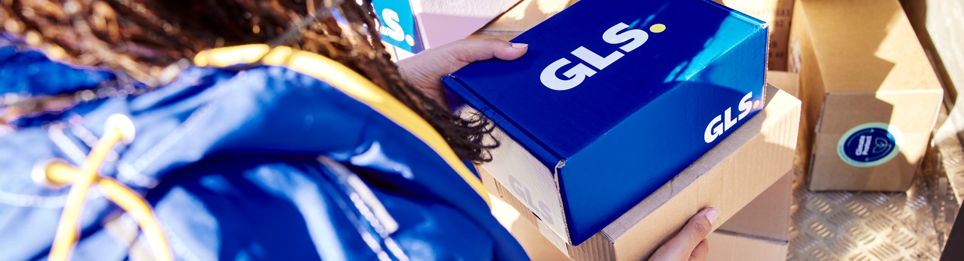 GLS driver holding GLS parcels in her hands