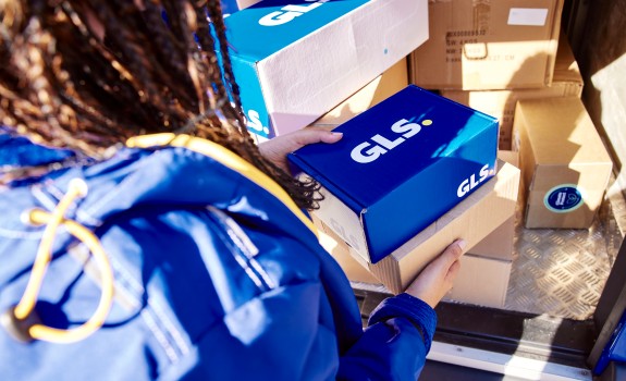 GLS driver holding GLS parcels in her hands