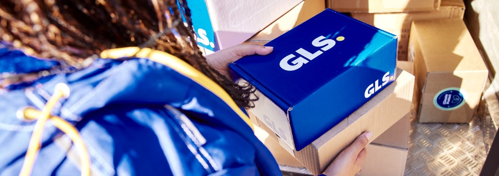 GLS driver holding GLS parcels in her hands