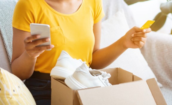 Young woman discovering her online purchase