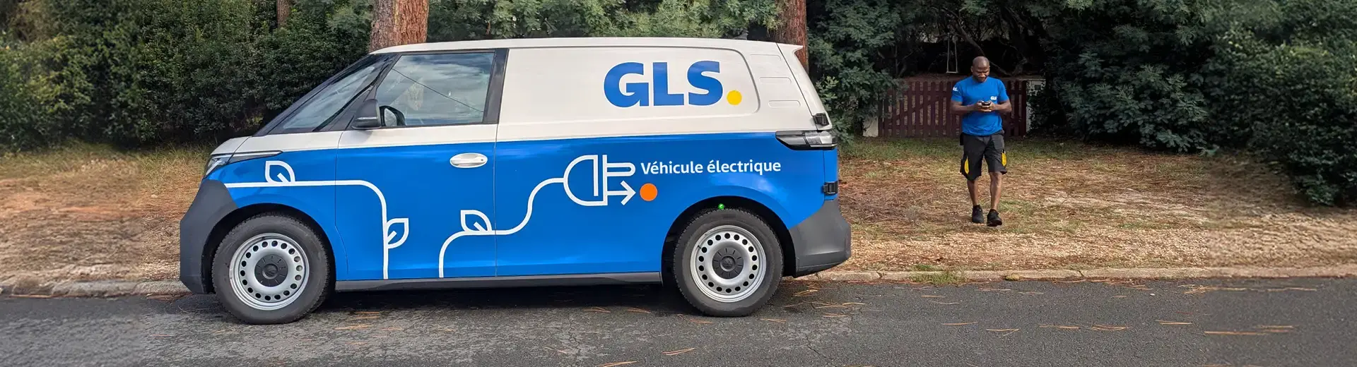 A GLS delivery driver uses an electric van in GLS colors