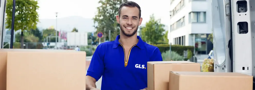 smiling GLS France driver unloading parcel at the back of the truck