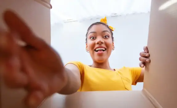 A happy customer unboxing her parcel delivered by GLS