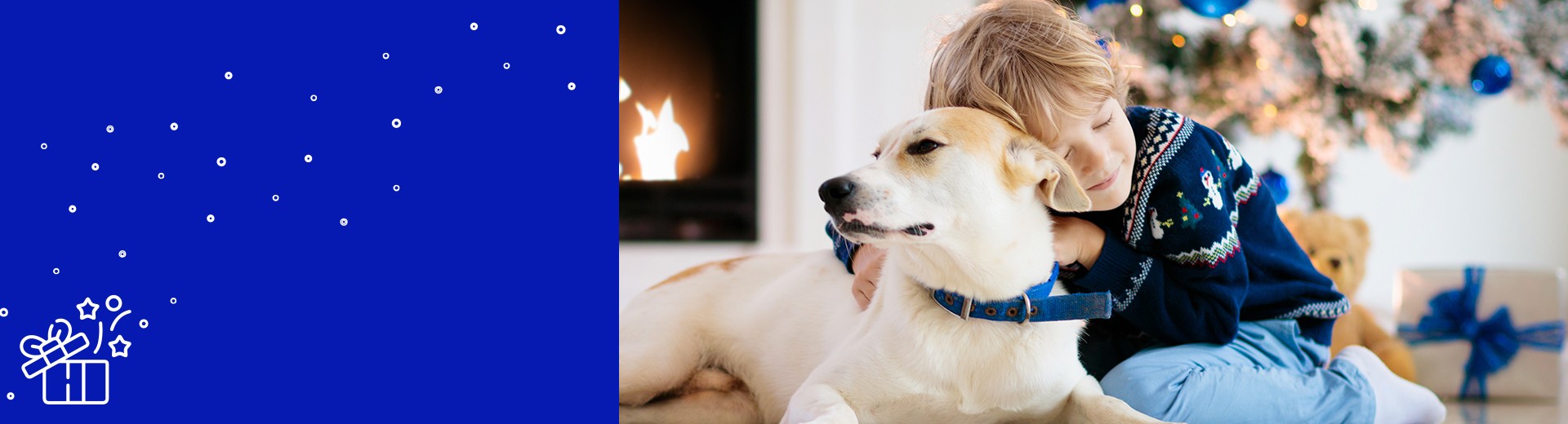 kid and dog in front of the christmas tree